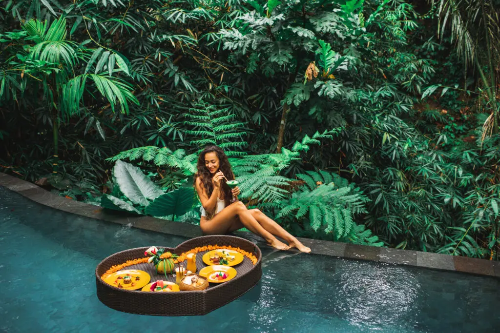 Girl,Relaxing,And,Eating,Floating,Breakfast,In,Jungle,Pool,On