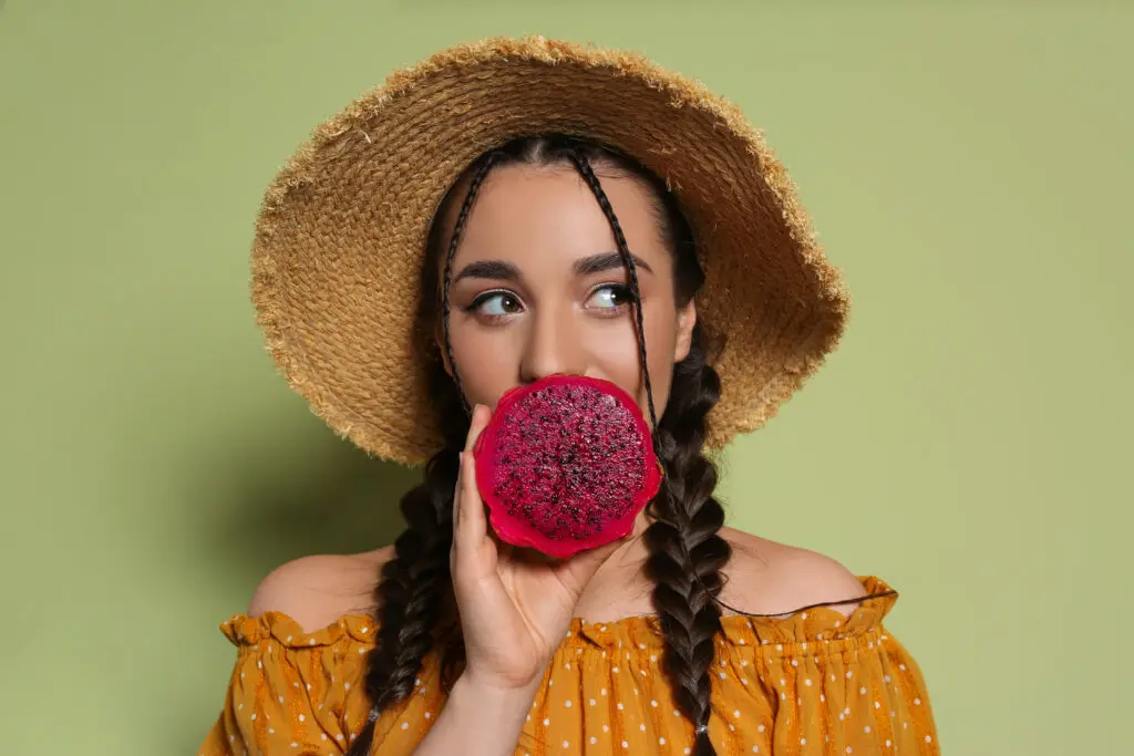 Young,Woman,With,Fresh,Pitahaya,On,Olive,Background.,Exotic,Fruit