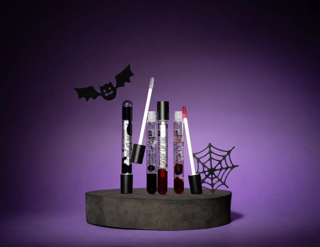 Sence Halloween Lip Oil on a purple Halloween backdrop