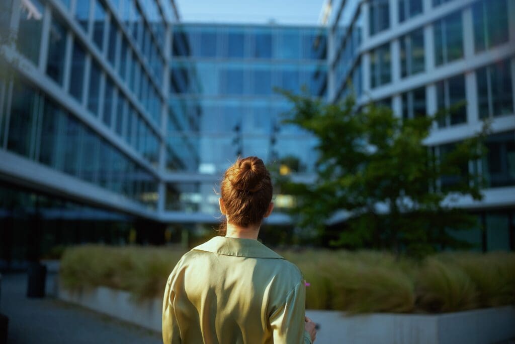 Seen,From,Behind,Middle,Aged,Woman,Employee,Near,Office,Building