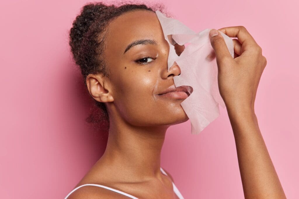 Beautiful,Woman,With,Curly,Combed,Hair,Puts,On,Facial,Mask Sence Face Sheet Mask application
